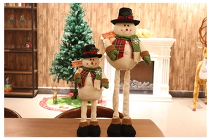 Detail of plush Christmas snowmen with Let It Snow signs in a cozy holiday indoor setting