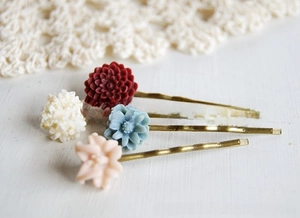 Detailed view of resin flower hair clips set in white, burgundy, blue, and pink colors
