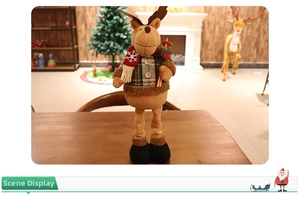 Detailed plush reindeer ornament wearing a green plaid shirt and a red snowflake scarf