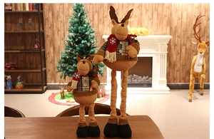 Detailed view of two telescopic plush reindeer dolls with snowflake scarves for Christmas