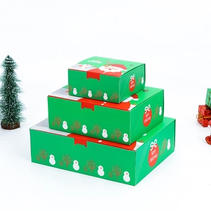 Three-piece stackable green Christmas gift boxes with red lids and festive Santa patterns