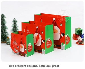 Various sizes of Christmas gift bags with Santa illustrations and festive red ropes