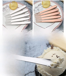 Detail of dual-prong stainless steel fruit fork in silver and rose gold finish