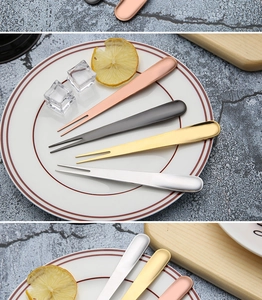 Set of four stainless steel fruit forks in gold, silver, rose gold, and black colors