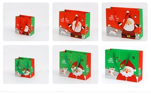 Christmas paper gift bags in various sizes featuring Santa Claus and reindeer patterns