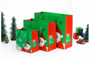 Three sizes of red and green Christmas gift bags with Santa cartoons and ribbon handles