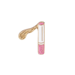 Detailed close-up of a cartoon cigarette enamel pin with gold plating and white finish