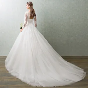 Detailed back view of a white lace wedding dress with open back and lace-up corset detail