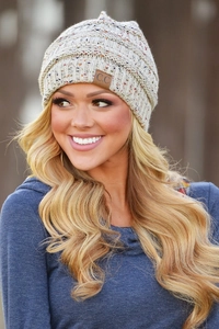 Close-up of beige knit beanie showing detailed texture and signature C.C brand leather patch