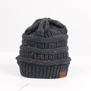 Macro shot of dark grey knit beanie featuring colorful confetti yarn and C.C leather patch
