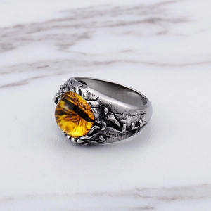 Vintage stainless steel ring with a yellow dragon eye stone in a textured claw setting