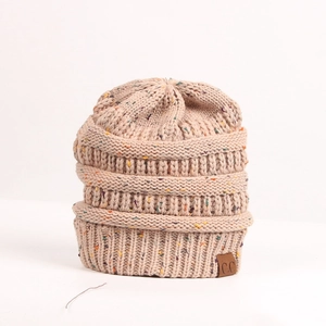 Close-up of beige chunky knit beanie featuring colorful speckles and a brown C.C leather patch