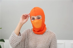 Macro detail of the orange winter balaclava showing the breathable mesh nose and mouth panel
