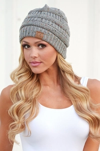 Detail of grey cable knit beanie with multi-color flecks and brown leather C.C patch