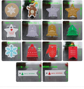 Macro display of colorful Christmas gift tags in various festive shapes and sizes