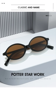 Detailed view of vintage oval sunglasses with thick black frames on a minimalist stand
