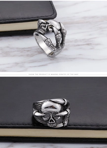 Detail of gothic silver skull claw ring with vintage oxidized finish on leather background