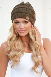 Close-up of olive green knit beanie with speckled yarn and brown C.C leather logo patch