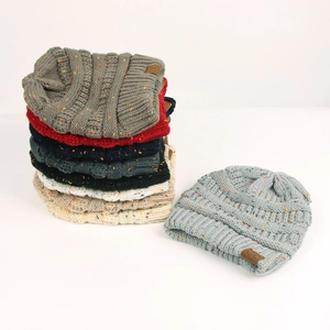 Close-up of confetti knit beanie featuring soft marled yarn and branded brown leather patch