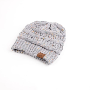 Detailed close-up of grey cable knit beanie with colorful speckles and leather C.C brand tag