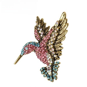 Vintage gold-tone hummingbird brooch pin sparkling with pink and blue rhinestones for women.