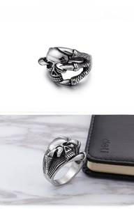 Macro detail of vintage punk eagle claw ring with a skull motif and dark textured finish