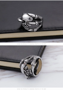 Detailed view of a vintage gothic skull ring with eagle claws in an antique silver finish