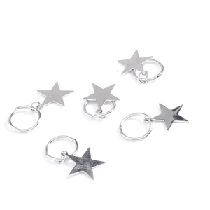 Detailed view of silver star charms with small metal rings for DIY hair braiding
