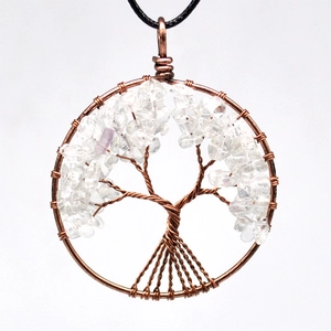 Macro detail of handmade tree of life pendant with copper wire and amethyst stones