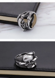 Macro detail of gothic skull and eagle claw ring with vintage silver oxidized finish