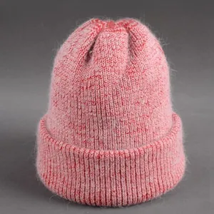Close-up of pink knit beanie with fuzzy texture and thick cuffed edge for winter warmth