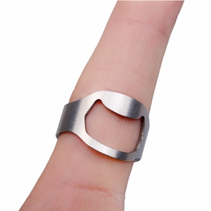 Close-up of silver stainless steel bottle opener ring with brushed metal texture