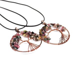 Detail of tree of life pendant with colorful crystals and handmade bronze wire wrapping