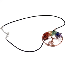 Macro shot of handcrafted Seven Chakra Tree of Life necklace with colorful gemstones