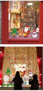 Window display of musical Santa Claus and reindeer stickers with Merry Christmas text