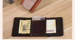 Inside view of a tri-fold brown PU leather wallet showing card slots and cash compartments