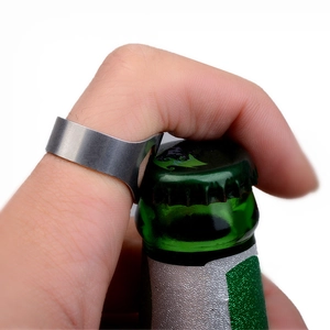 Practical stainless steel ring bottle opener shown opening a beer bottle cap