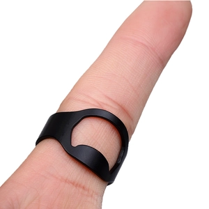 Close-up of black matte stainless steel ring bottle opener worn on a finger