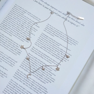 Detail of S925 sterling silver stamp on moon and star necklace with pavé settings