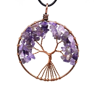 Macro shot of copper wire tree of life necklace with amethyst crystals on black cord