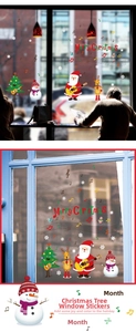 Detail view of musical Santa Claus and reindeer window stickers on a restaurant glass pane