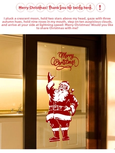 Détail d'autocollant Père Noël et Merry Christmas sur une porte de cuisine en verre