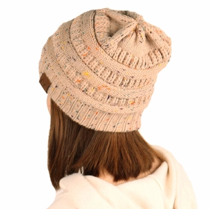 Close-up of chunky knit beanie with colorful confetti flecks and C.C leather brand label