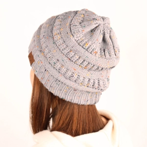 Detail of gray knit beanie with colorful confetti flecks and brown leather CC patch