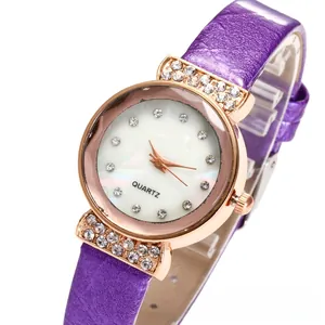 Detail of rose gold quartz watch with purple leather strap and rhinestone encrusted bezel