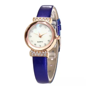 Detail of rose gold quartz watch with crystal indices and blue leather strap