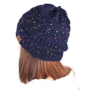 Detail of navy knit beanie with colorful flecks and a brown C.C leather logo patch