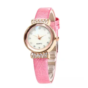 Macro shot of rose gold watch case with crystal accents and pink leather strap texture
