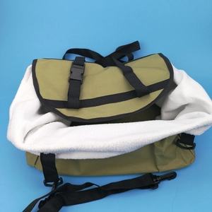 Detail of army green canvas pet bag with warm white fleece lining and adjustable strap