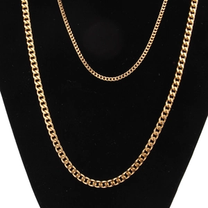 Detail of 3mm gold stainless steel Cuban chain necklaces on a black display neck